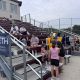 Group sitting on bleachers at the Widseth-Pine Island Softball Game-Summer 2026